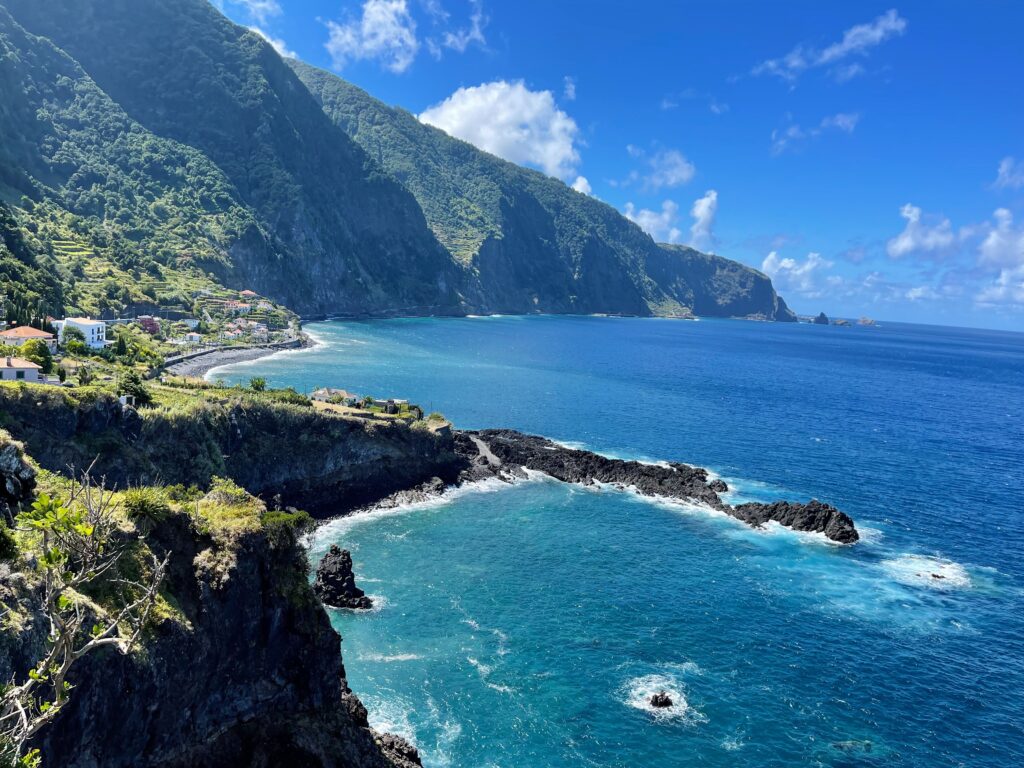 A stunning view of Madeira's northern coastline near Seixal, looking towards the beach area and Seixal Natural Pools.